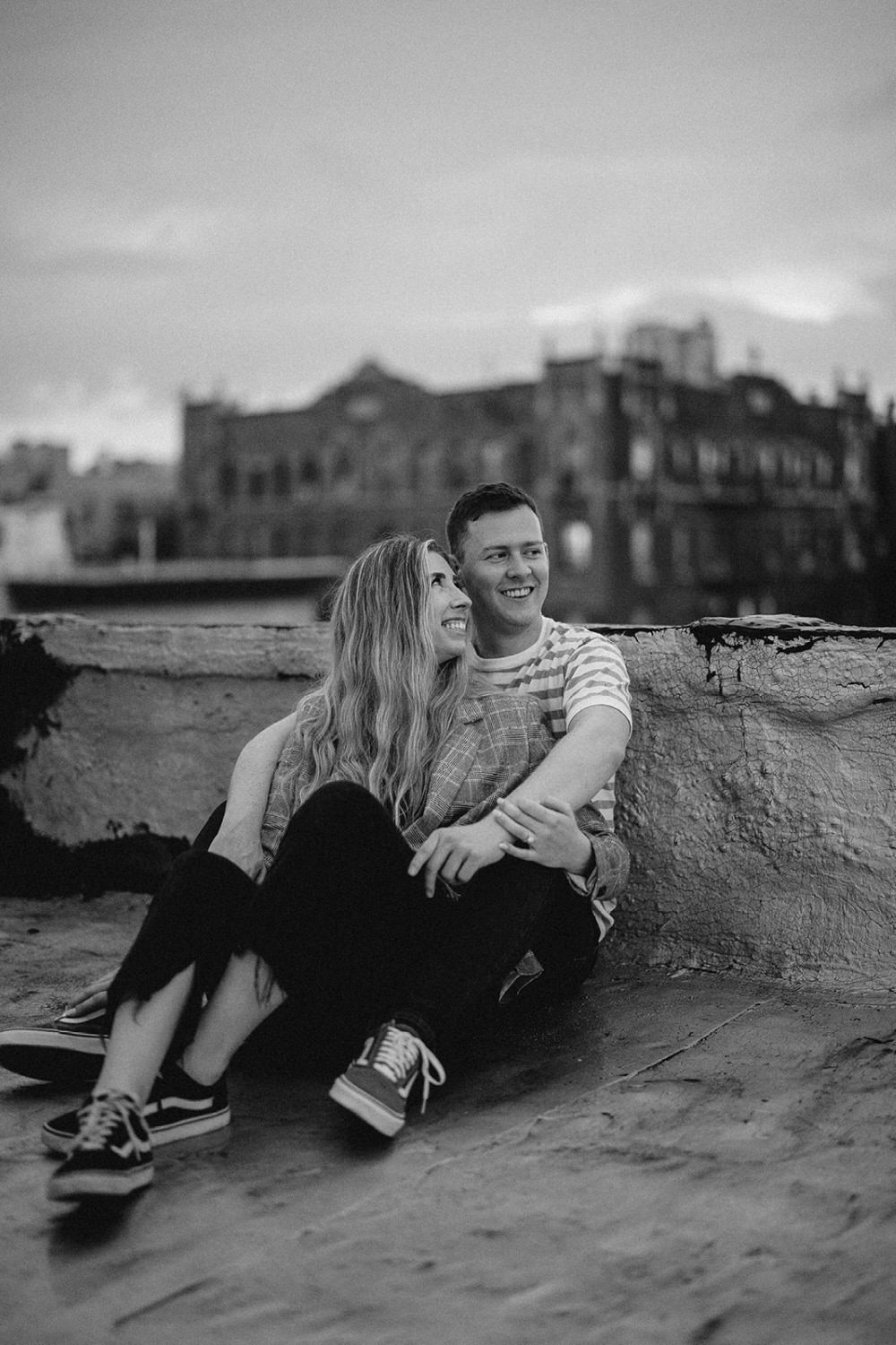 couple leans into each other during engagement photos in new york city