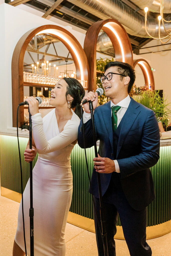 couple sings karaoke at their wedding at the tinsmith in madison wisconsin