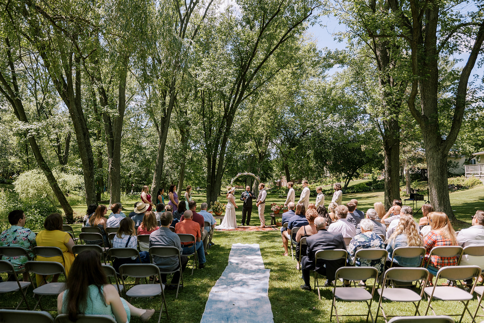 a bride and groom stand at the altar during their backyard ceremony in central wisconsin