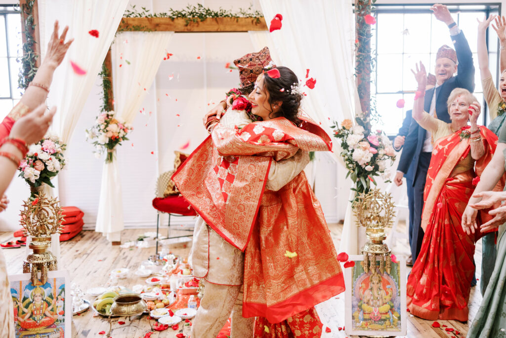bride and groom embraces after they are pronounced husband and wife at traditional nepalese wedding