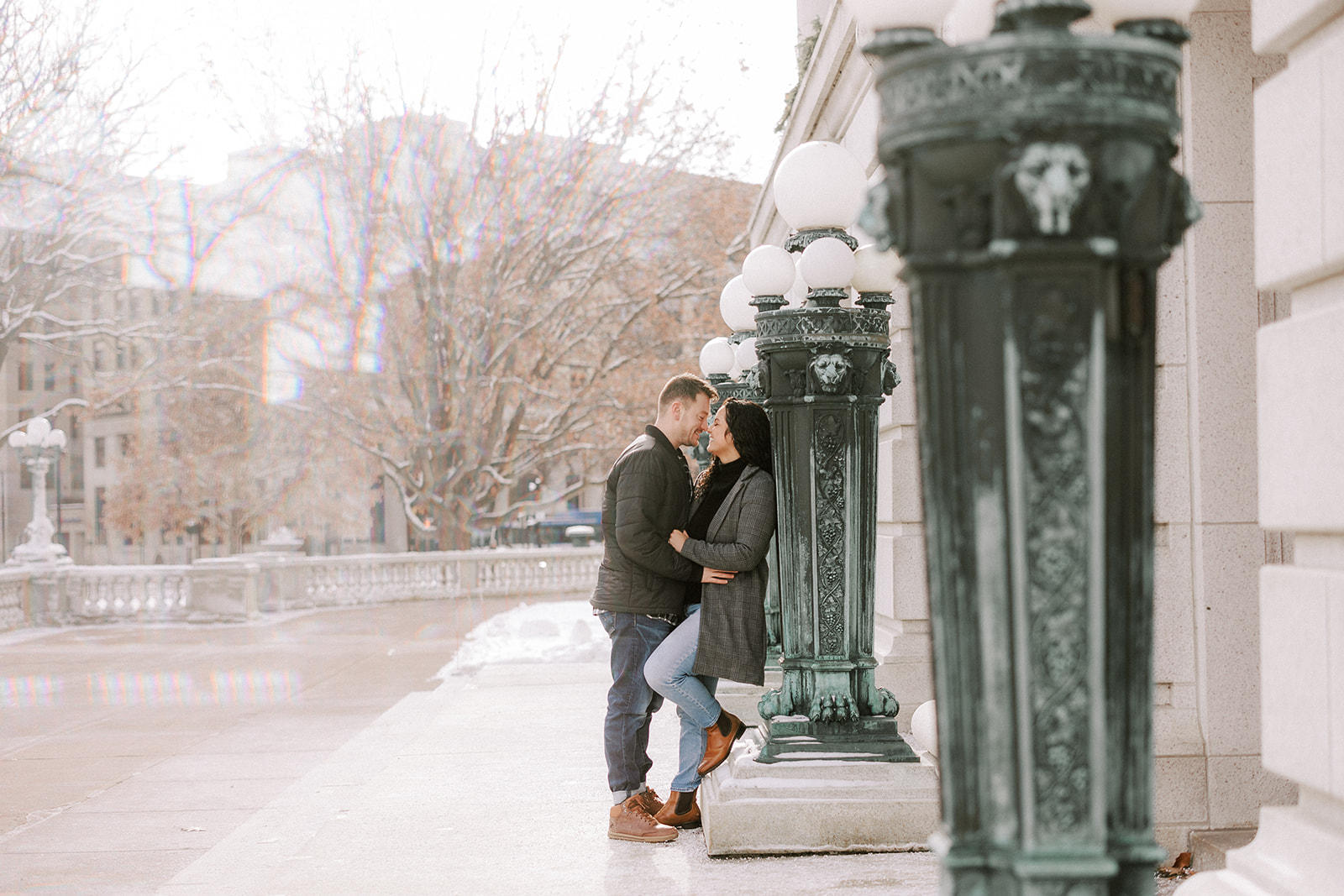 couple kisses outside of the capitol in madison wisconsin