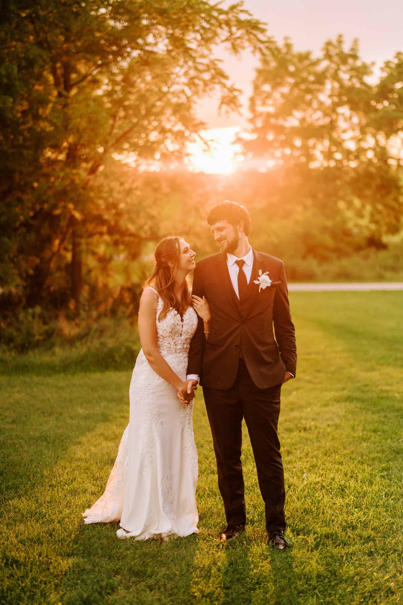 bride and groom cuddle as the sun sets on their wedding day during their reception