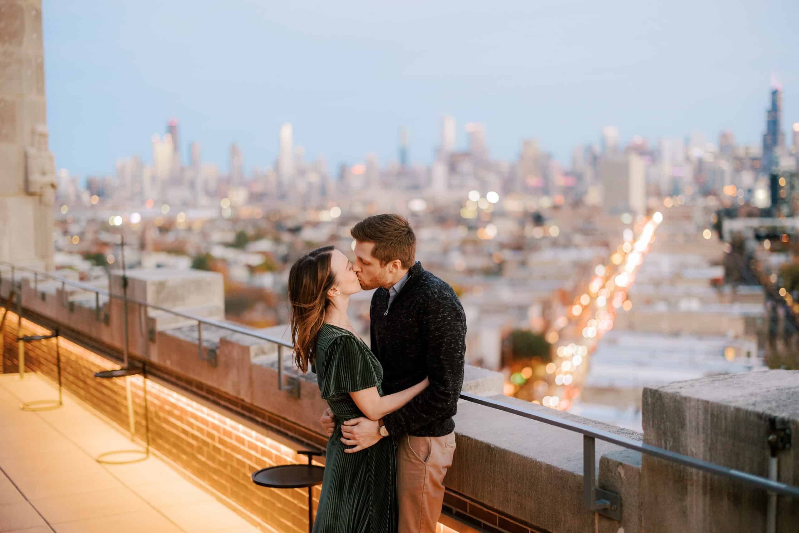 couple kisses on rooftop in wicker park chicago during their fall engagement session