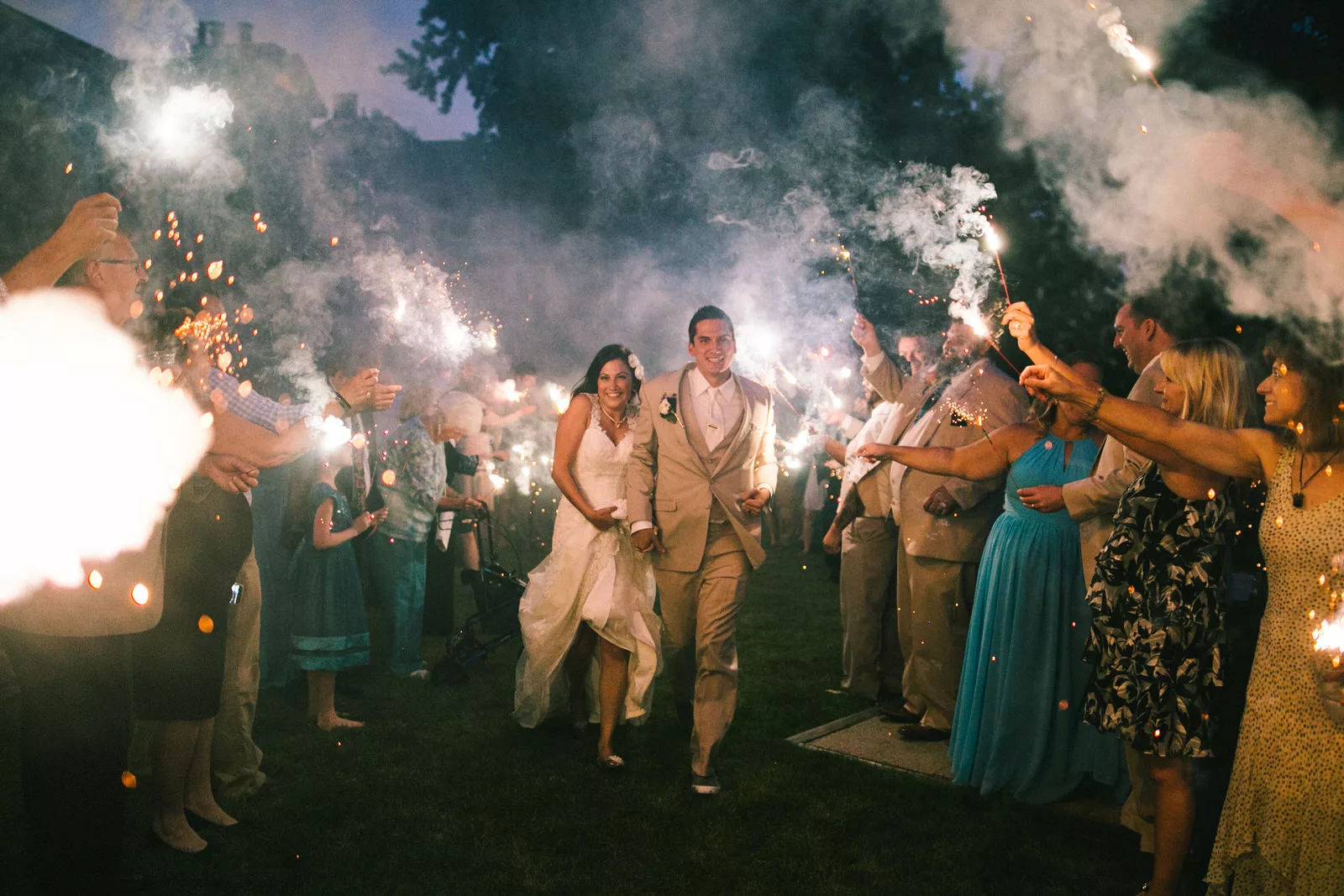 couple runs through sparklers on their wedding day in madison wisconsin