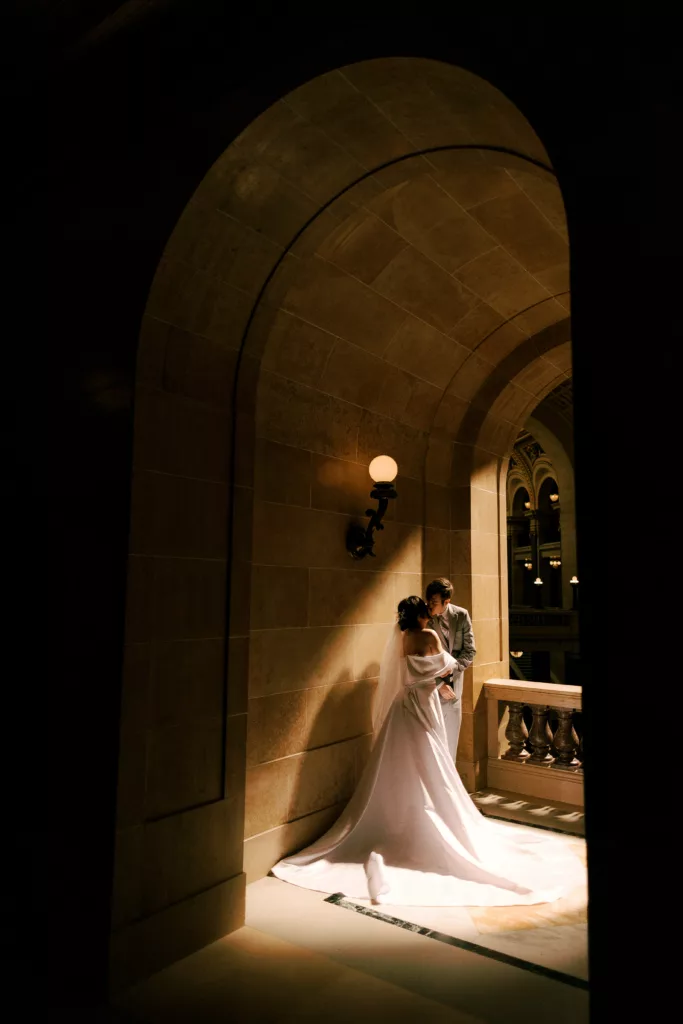 couple kisses in the madison wisconsin capitol buildling after their wedding ceremony
