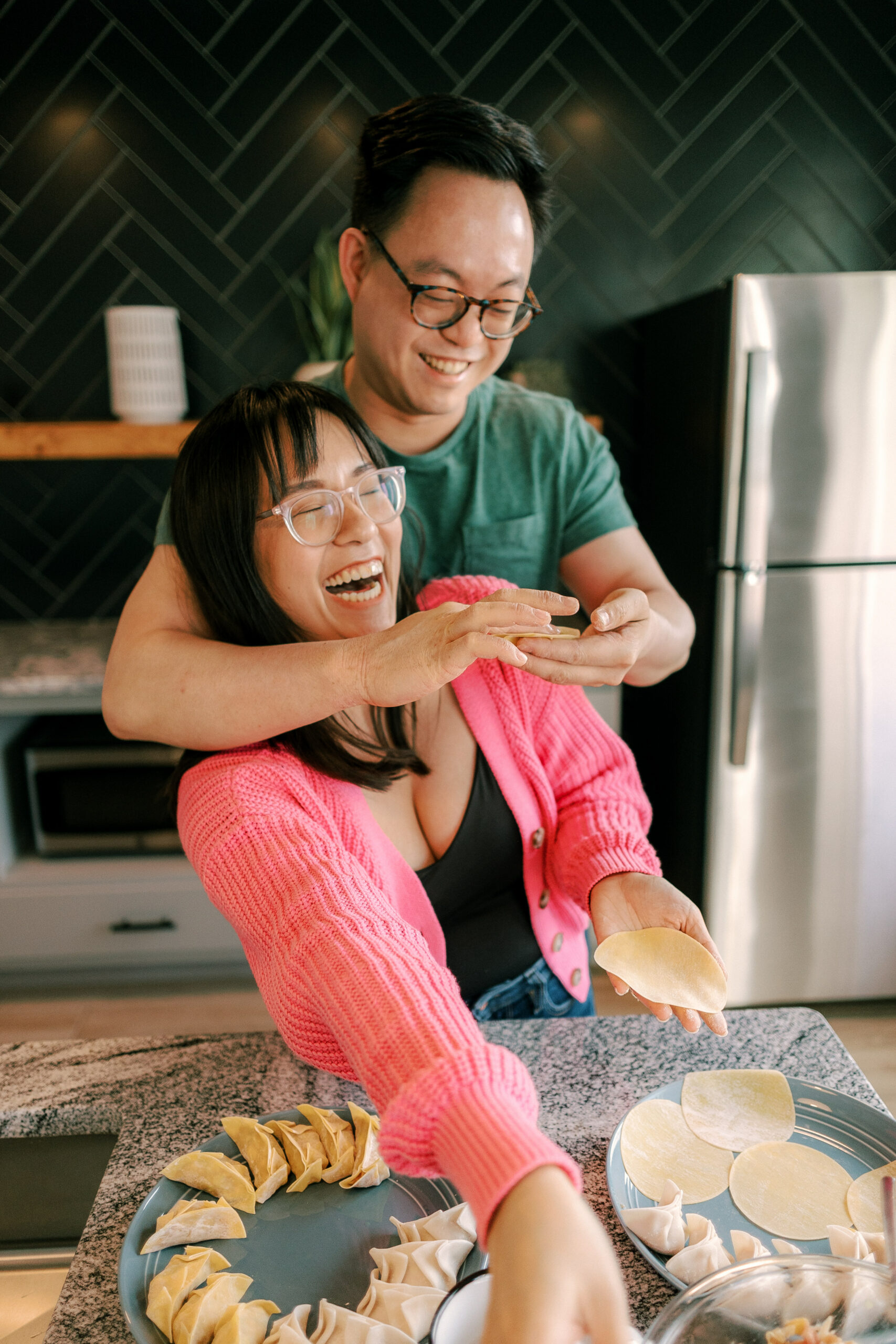 an engaged couple makes dumplings in their home in madison wisconsin