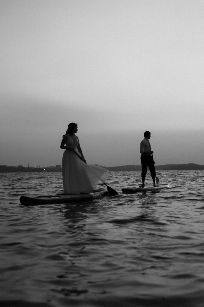 bride and groom on paddle boards on their wedding day in madison wisconsin