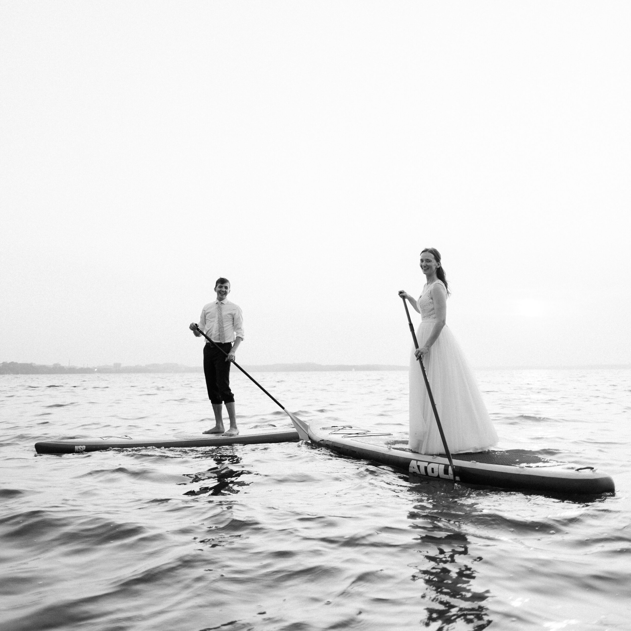 bride and groom kayak on the lake at Olin Park in Madison, Wisconsin
