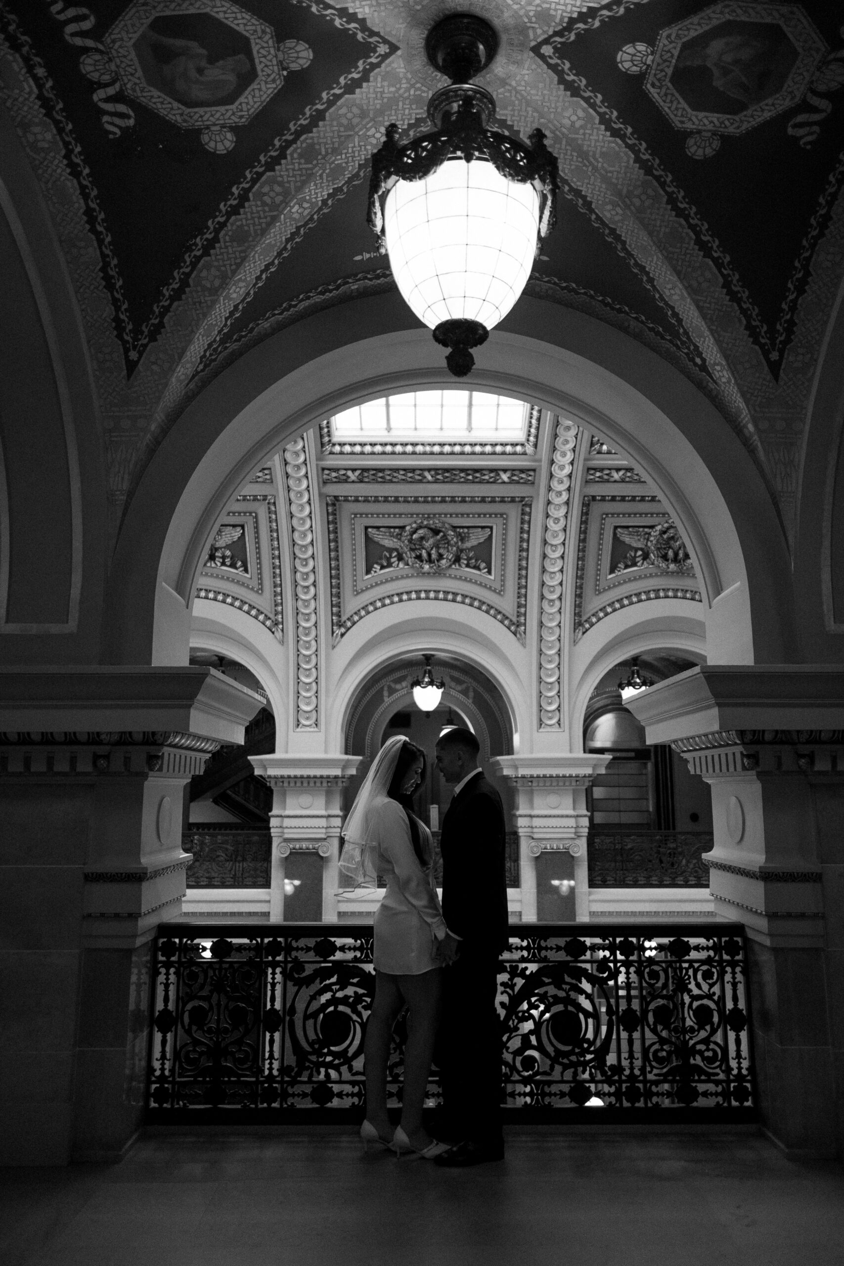 couple embraces in the madison wisconsin capitol building during their elopement day