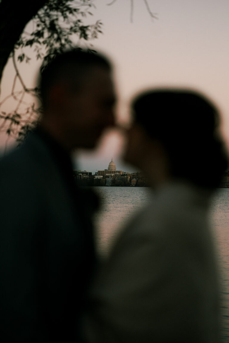 couple and their silhouette with the capitol behind them in madison, wisconsin