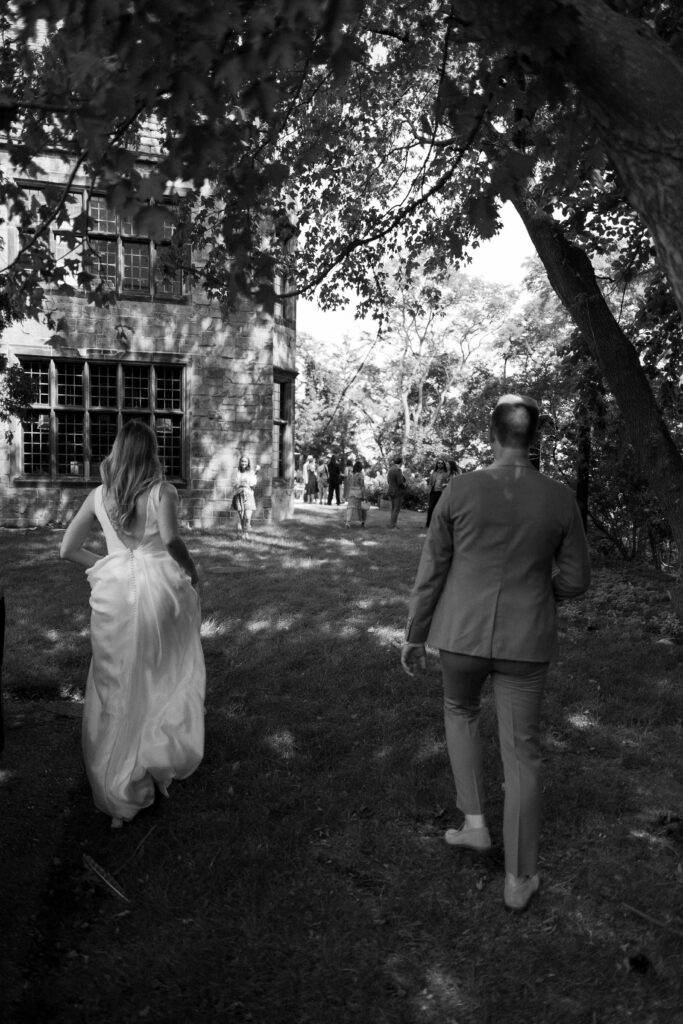 bride and groom walk back to their guests during their intimate wedding in wisconsin