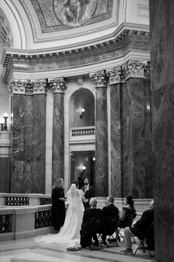 couple has their ceremony in the madison wisconsin capitol building with their close family and friends
