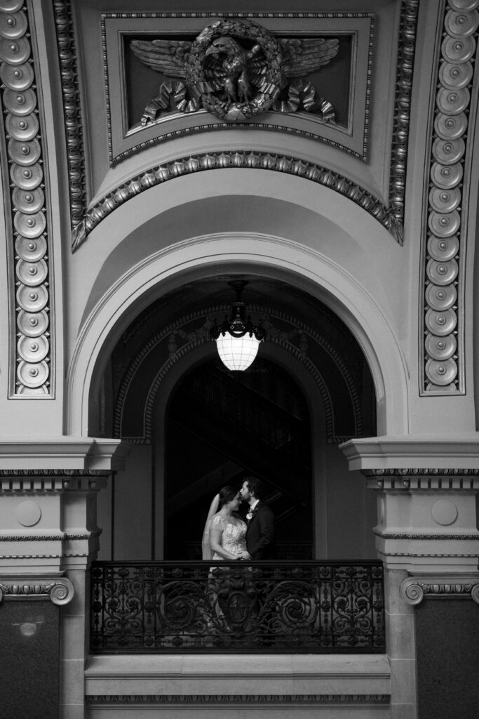 bride and groom kiss in the wisconsin capitol building on their elopement day